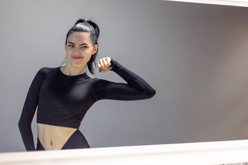 Beautiful woman in sportswear looking at mirror.