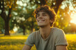 © Victor - Content and Carefree Young Man in the Park, Smiling and Looking into the Distance