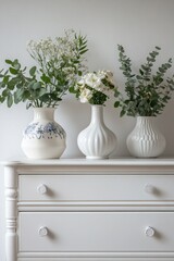 Poster - Three decorative vases filled with flowers sit on a dresser, perfect for home decor or still life photography