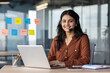 © Liubomir - Smiling woman with headset working on laptop in office. Customer service concept. Professional atmosphere with focus on communication and productivity.