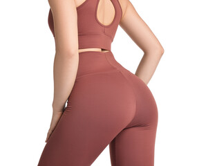 Wall Mural - Woman wearing sports leggings and bra on white background, closeup