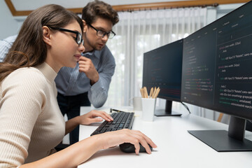 Team skilled developers program thinking newest coding creative website planning software project on two pc screen, comparing with typing full stack data analyzing prompt design at office. Postulate.