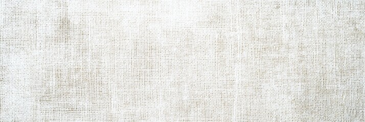 Poster - The soft, natural linen fabric is elegantly arranged on a wooden surface, showcasing its texture and subtle color variations illuminated by daylight