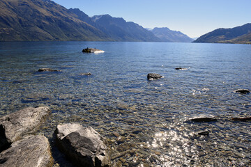 panoramic scenic view of Lake Wakatipu with mountains in the background near Queenstown, South Island, New Zealand
