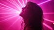 © Orod - A young woman enjoying herself on the dance floor, illuminated by bright pink laser lights