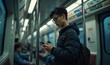© Makaron - A young person using a smartphone while riding the subway, embodying modern urban life and technology use in transit.