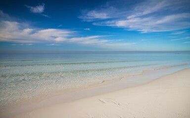 Wall Mural - Beach calm water sky. Serene seascape featuring a tranquil beach with clear blue water and a bright sky. Perfect for relaxation and peace.