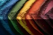 © Umi Sakina - Colorful powder pigments in a rainbow pattern with a shadow reflection.
