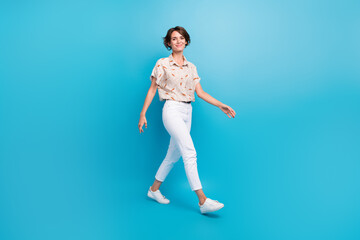 Sticker - Full length profile portrait of stunning satisfied person walking isolated on bright blue color background