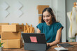 © amnaj - Young asian woman entrepreneur is working from home office using digital tablet to check customer order on online shopping platform