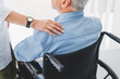© InsideCreativeHouse - Close up of medical worker supporting disabled old mature man sitting in wheelchair