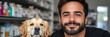 © Vertigo Images - A young man with a beard smiles for the camera while his golden retriever looks on.