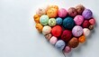 © MW Photography  - balls of yarn and wool in a heart shape on white background