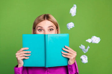 Poster - Portrait of nice young lady book cover face flying crumpled paper wear violet shirt isolated on green color background