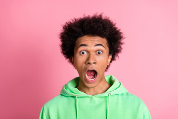 Wall Mural - Photo of nice young man open mouth wear green hoodie isolared on pink color background