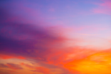 beautiful sunset sky with amazing colorful clouds against deep blue