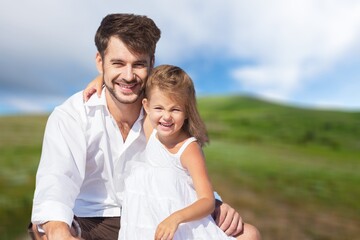 Young happy father with little child daughter outdoors