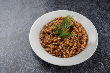 A plate of food with a green herb on top