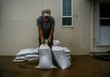 © artem - Flood protection and preparedness with sandbags near home in rainy weather