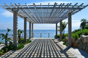 Beautiful pergola casting shadows on the ground overlooking the ocean