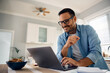 © Drazen - Happy man surfing  net on laptop at home.