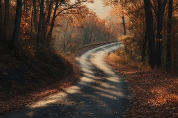 Wall Mural - a winding road through an autumn forest, with leaves of various shades of orange and red covering th