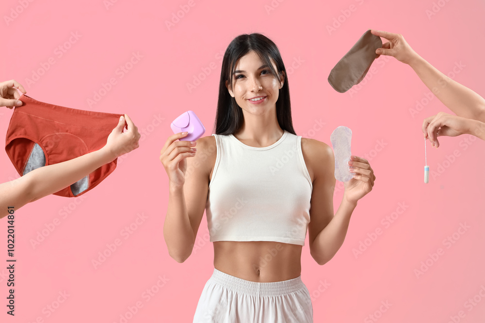 Young woman and hands with menstrual things on pink background