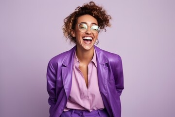 Portrait of a happy african american woman laughing against purple background