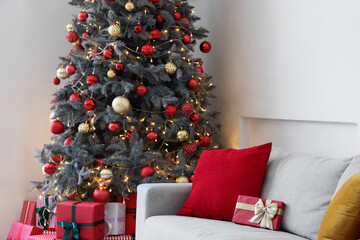 Wall Mural - Interior of festive living room with grey sofa and gift boxes under Christmas tree