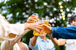 © CandyRetriever  - Group of Happy Asian millennial generation people friends enjoy and fun toasting beer glasses celebration reunion meeting at outdoor dinner party in the garden at restaurant on holiday vacation.