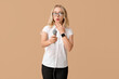 © Pixel-Shot - Portrait of shocked female journalist with microphone taking interview on beige background
