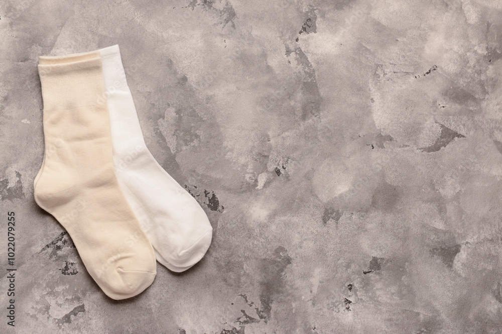 Different basic color socks on grey grunge background