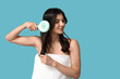 © Pixel-Shot - Beautiful young woman brushing her hair on blue background