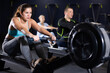 © JackF - Portrait of concentrated young girl doing intense full body workout in gym, exercising on rowing machine