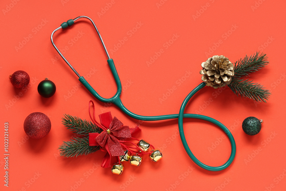Stethoscope with Christmas tree branches and decor on red background