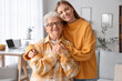 © Pixel-Shot - Happy senior woman and her granddaughter at home
