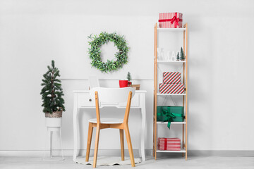 Canvas Print - Interior of office with workplace, Christmas mistletoe wreath and presents