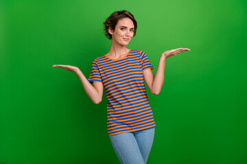 Poster - Photo of pretty person arms palms hold demonstrate empty space vs scales isolated on green color background