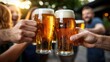 © BOJOShop - Friends Toasting Beer Glasses at Outdoor Party   St  Patrick s Day Celebration