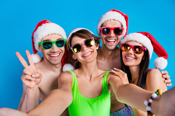 Canvas Print - Photo of happy people couple girlfriends boyfriends make selfie on new year resort isolated blue color background