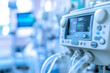 © mat - A medical ventilator machine with detailed control panel and tubing, positioned in a hospital room.