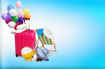 Poster - Suitcase with set of beach accessories on color  background