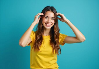 Relaxed Smiling Female Model in Yellow Shirt Posing Against a Blue Background - Capturing a Natural and Approachable Expression