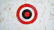© YM Creative Studio - Bullseye Target on Weathered Wall, Red and White Concentric Circles, Graphic Symbol on Textured Background, Urban Art, Precision Concept