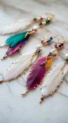 elegant white purple and gold feather earrings on white marble background