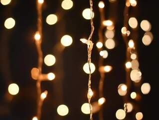 Wall Mural - warm bokeh lights on dark background for festive mood