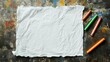 © LouvrianDesign - A blank white sheet of paper with wax crayons lies