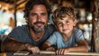 © Budi - A man and a boy smiling together in a rustic setting, sharing a moment of connection.
