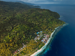 Coastline with mountains, ocean and cloudy weather on island in Indonesia. Travel destination concept.