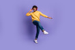 © deagreez - Photo of funky cool nice man wear trendy yellow clothes listen music dance isolated on purple color background